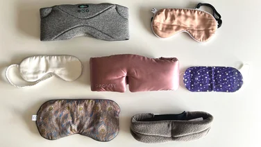 A series of sleep masks laid out against a white background, viewed from above