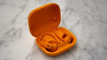 Angled view of the Beats Powerbeats Pro 2 in their case on a white countertop